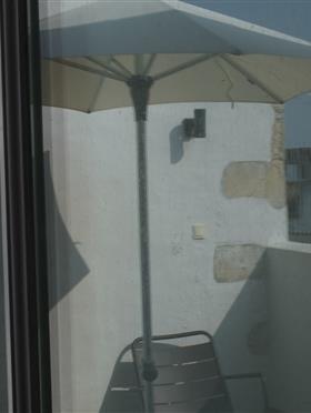 Terrace with umbrella at the senechal hotel
